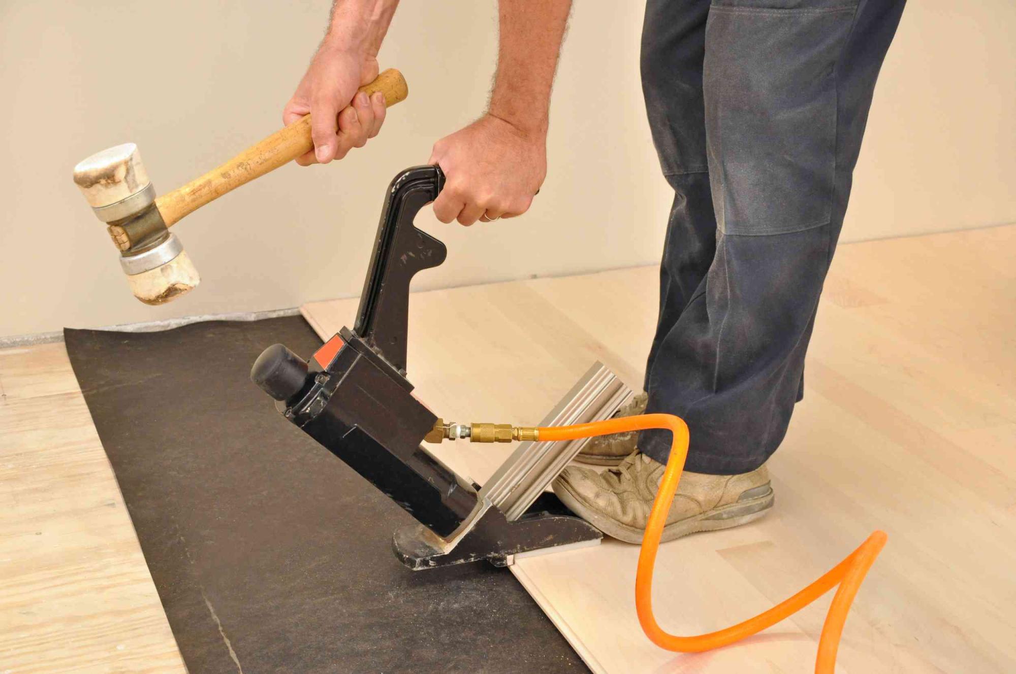 bigstock-Man-installing-hardwood-floori-30407972-c-r
